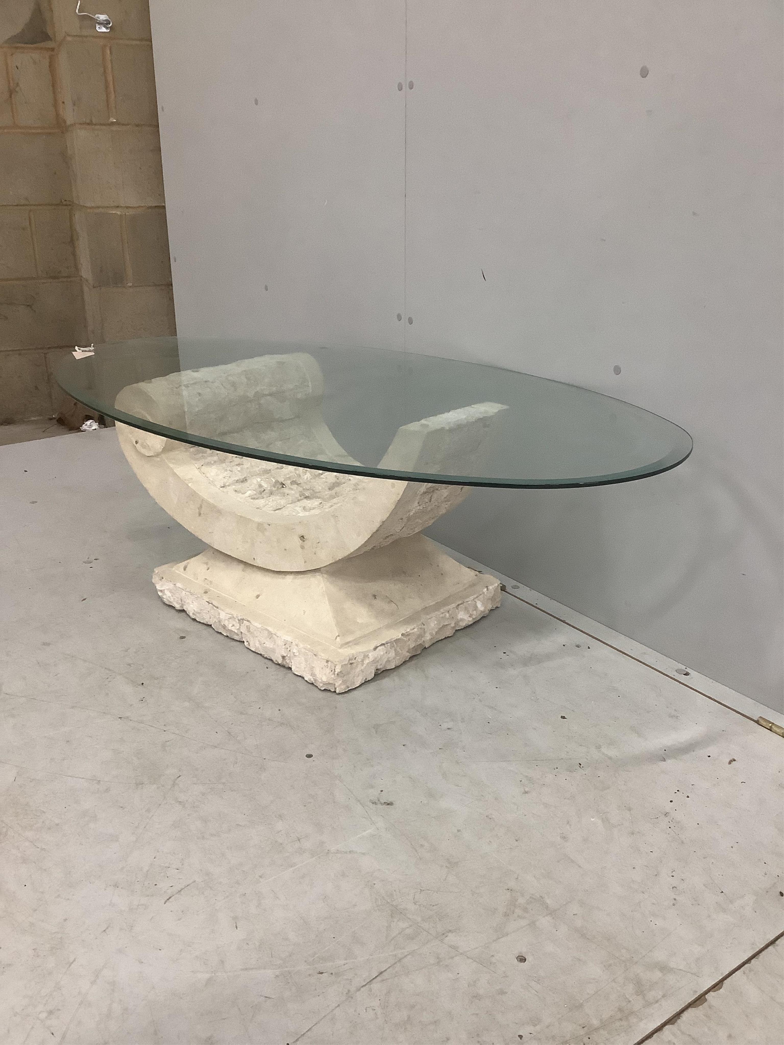 A Contemporary Italian design oval glass coffee table on composite 'C' scroll base, width 130cm, depth 70cm, height 41cm. Condition - good